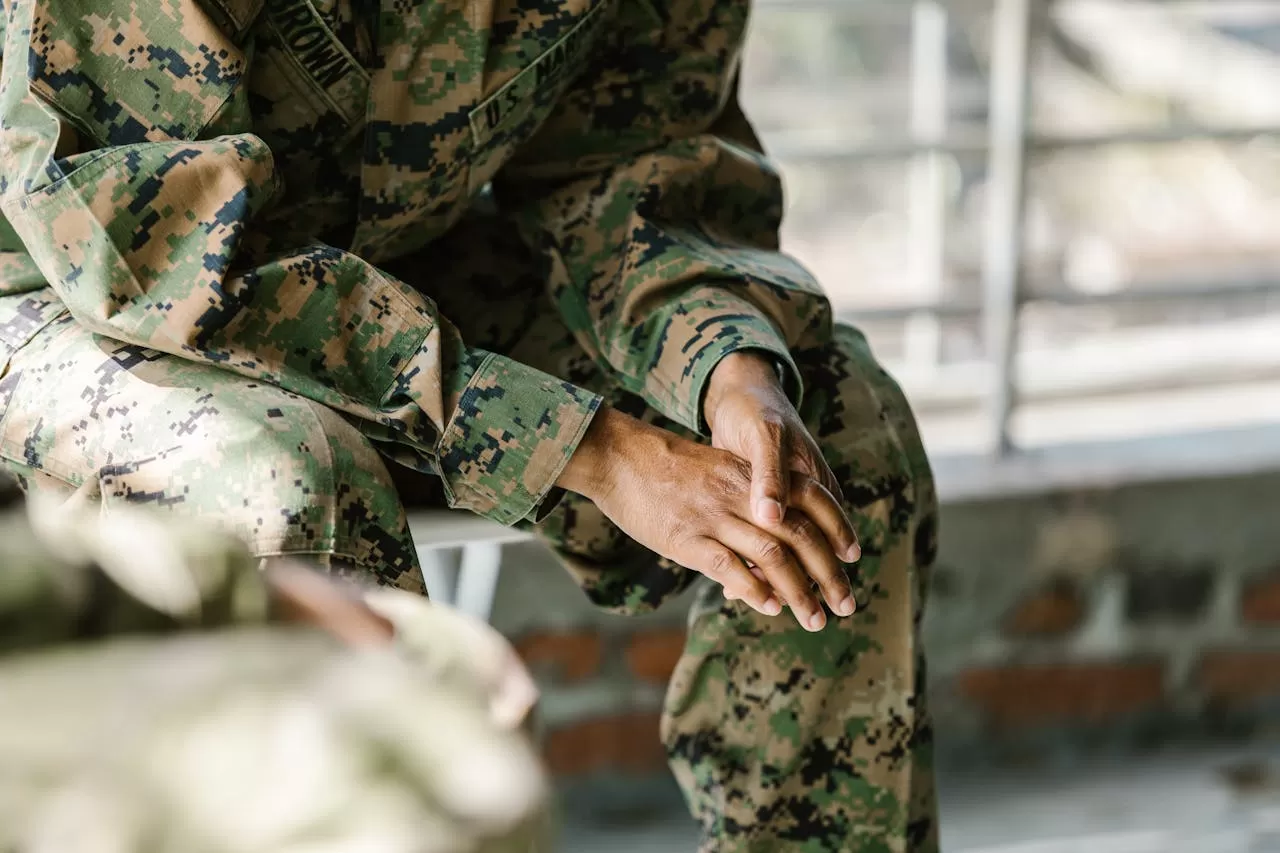 Veteran in camouflage with hands folded