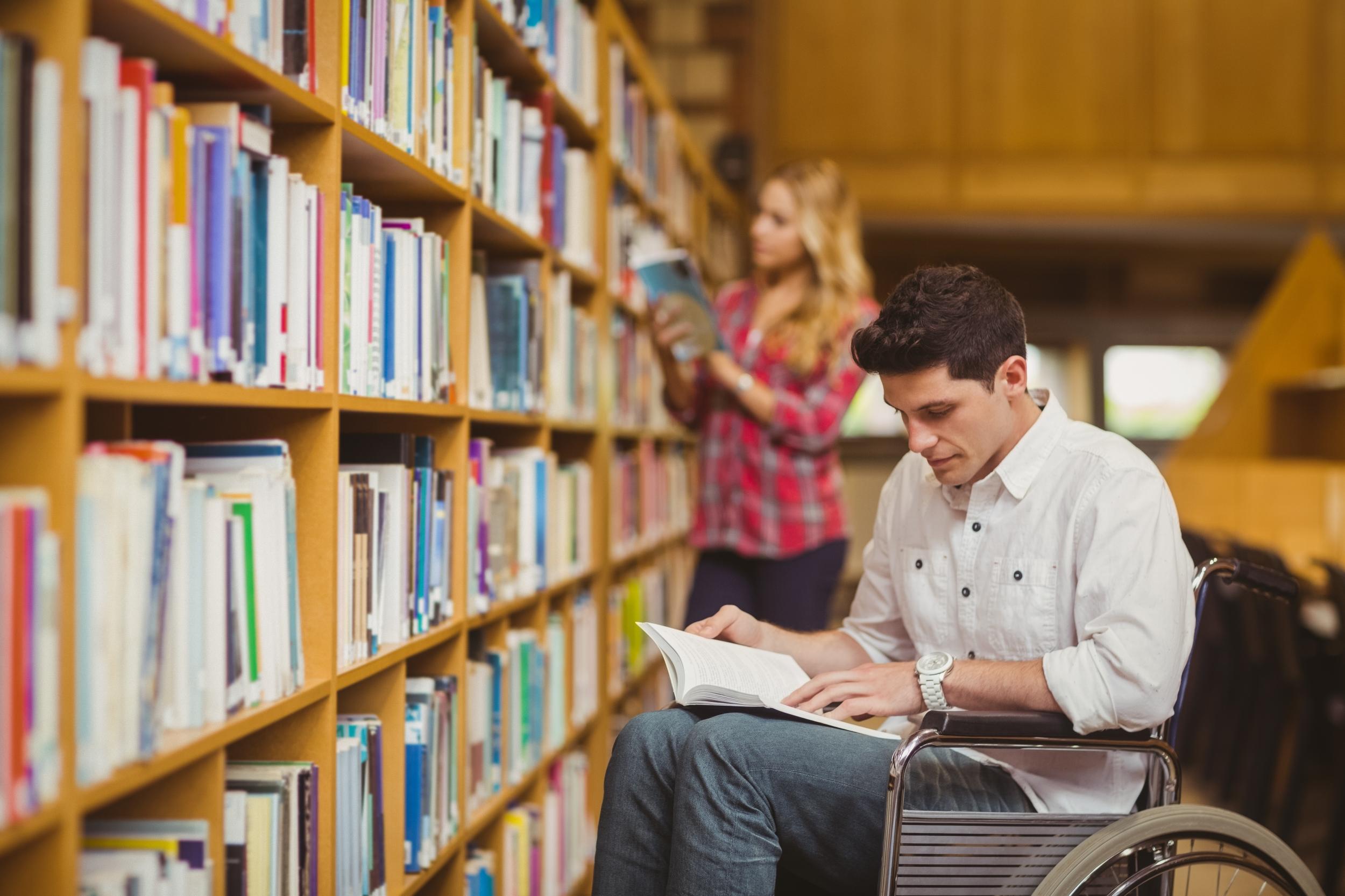 Student in a wheelchair in a library